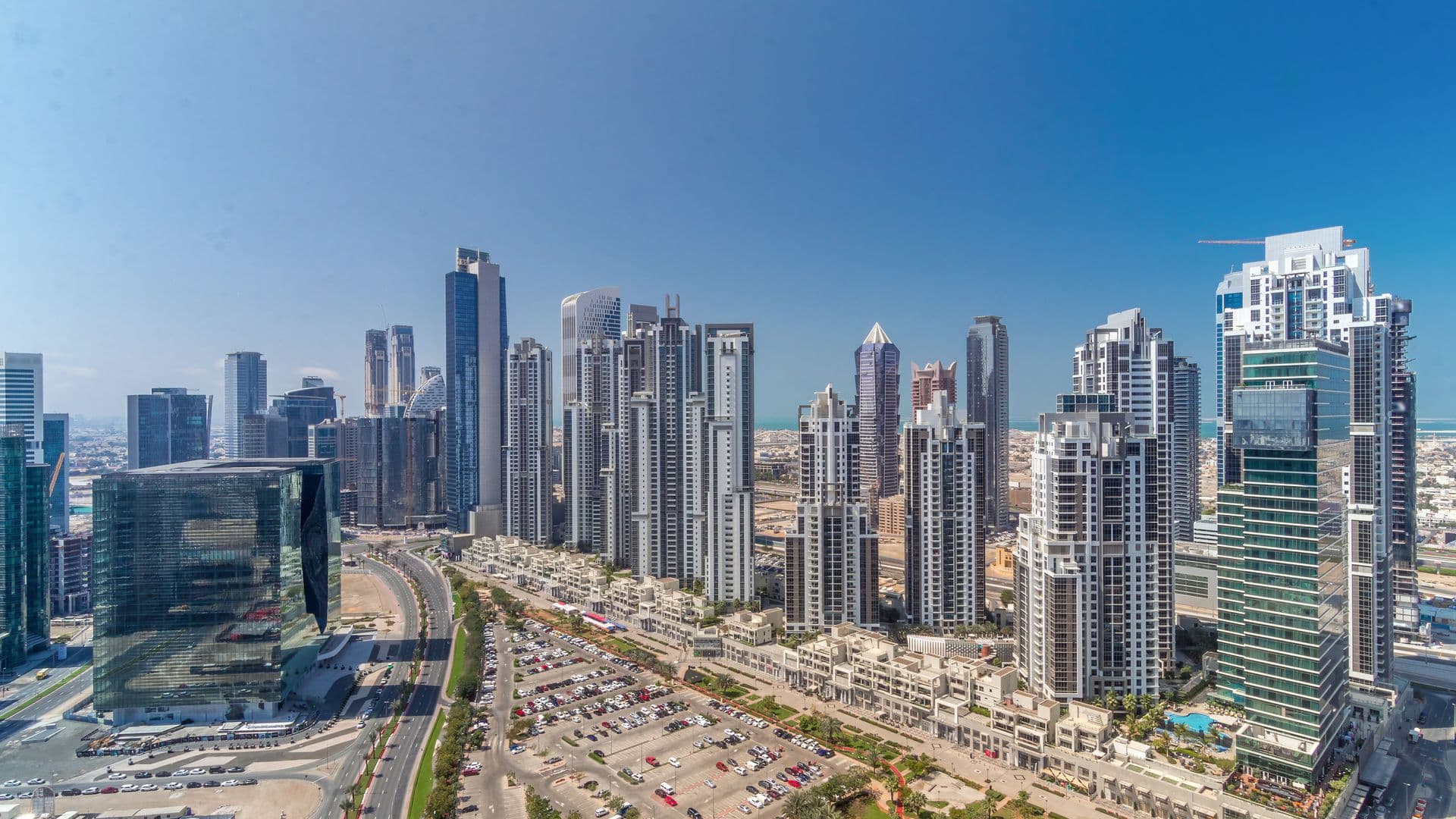 Aerial view of Business Bay, with residential and office towers on either side of a main road