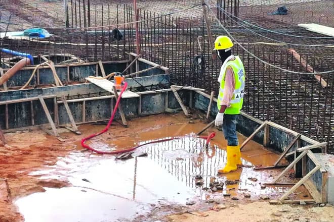 Standing water in a site excavation being treated for mosquito larvae